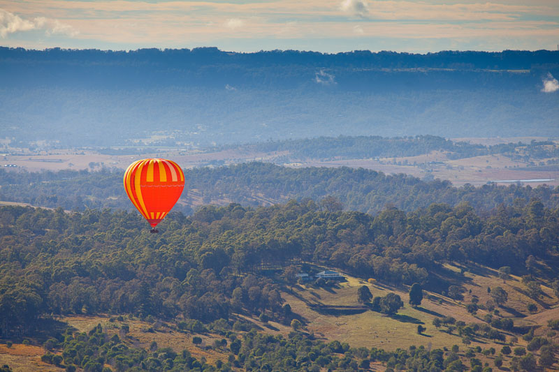 Balloon floating over the landscape below