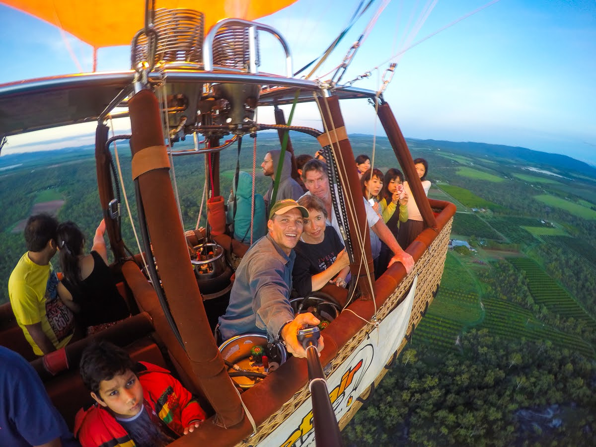 Hot air balloons drifting over the Atherton Tablelands at sunrise