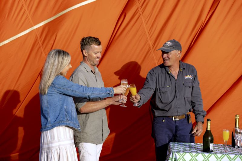 Pilot Frank shares  a toast with his passengers