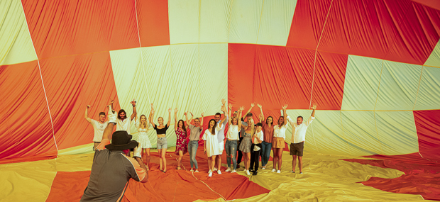 Fun group photo after landing in front of a hot air balloon