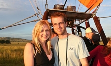 Young couple posing for a photo in their hot air balloon basket