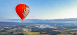 Koala hot air balloon floating over the Atherton Tablelands at sunrise near Cairns, Queensland, Australia